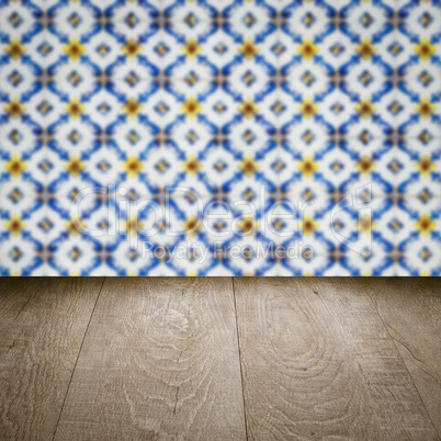 Wood table top and blur vintage ceramic tile pattern wall Wood table top and blur vintage ceramic tile pattern wall