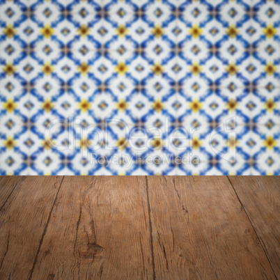 Wood table top and blur vintage ceramic tile pattern wall Wood table top and blur vintage ceramic tile pattern wall
