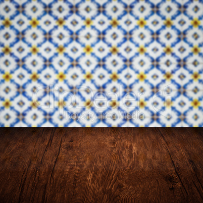 Wood table top and blur vintage ceramic tile pattern wall