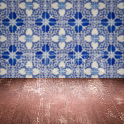 Wood table top and blur vintage ceramic tile pattern wall