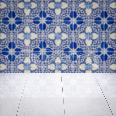 Wood table top and blur vintage ceramic tile pattern wall Wood table top and blur vintage ceramic tile pattern wall