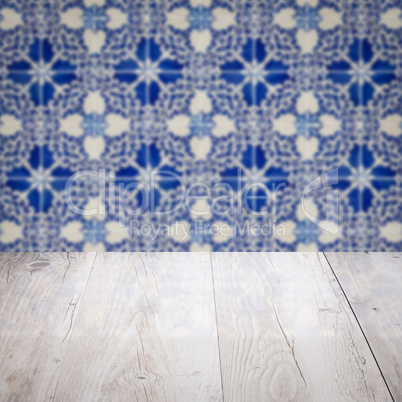 Wood table top and blur vintage ceramic tile pattern wall