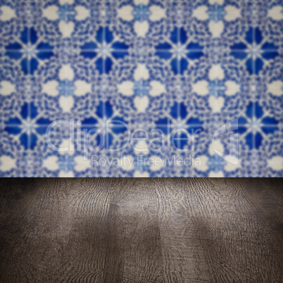 Wood table top and blur vintage ceramic tile pattern wall