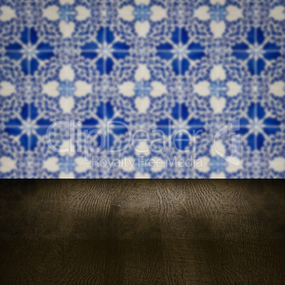 Wood table top and blur vintage ceramic tile pattern wall