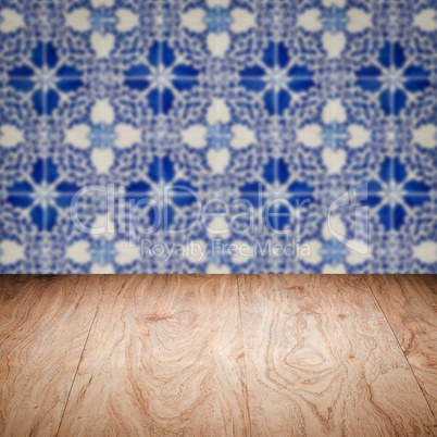 Wood table top and blur vintage ceramic tile pattern wall