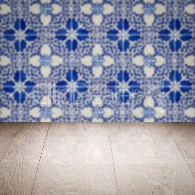 Wood table top and blur vintage ceramic tile pattern wall