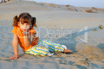 little girl playing in sand