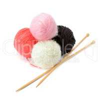 skeins of yarn and knitting needles isolated on a white backgrou