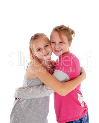 Smiling sisters hugging each other.