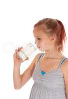 Young girl drinking a glass of milk.