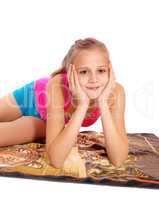 Closeup of young girl lying in bathing suit on floor.