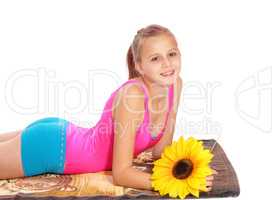 Young girl lying in bathing suit on a towel.