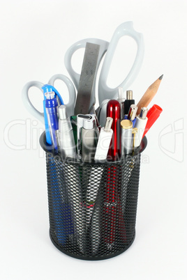 Pencil cup filled with colorful used pens, pencils and scissors