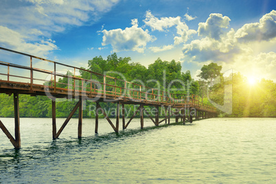 Wooden bridge over river. sunrise