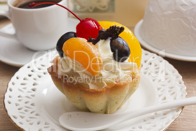 Cake with cream and cherries in a basket