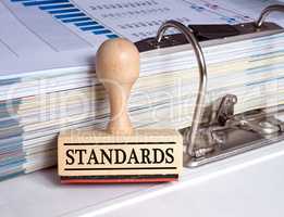 Standards stamp with binder in the office