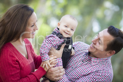 Little Baby Boy Having Fun With Mother and Father Outdoors