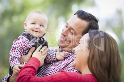 Little Baby Boy Having Fun With Mother and Father Outdoors