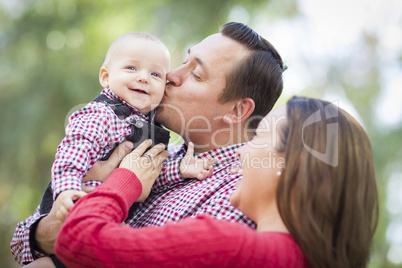 Little Baby Boy Having Fun With Mother and Father Outdoors