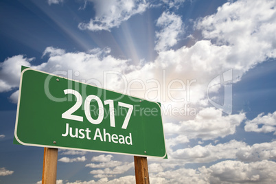 2017 Just Ahead Green Road Sign Against Clouds