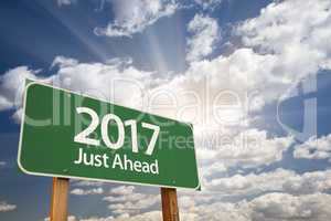 2017 Just Ahead Green Road Sign Against Clouds