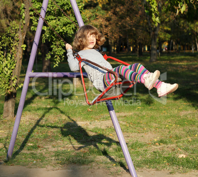 happy little girl on swing