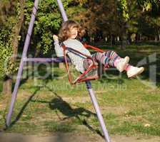 happy little girl on swing