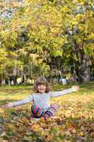 happy little girl in autumn park