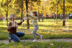 little girl running to embrace mother