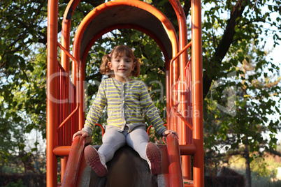 little girl on playground slide