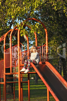 little girl on playground slide