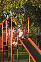 little girl on playground slide