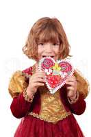 little girl eating gingerbread heart