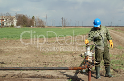 oil worker open pipeline valve