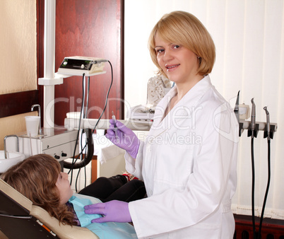 female dentist and child patient