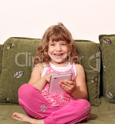 happy little girl fun with tablet pc