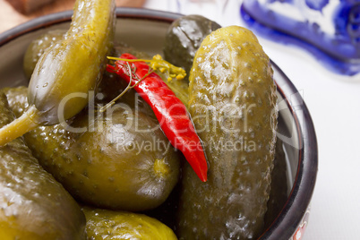 Pickled cucumbers in a clay bowl