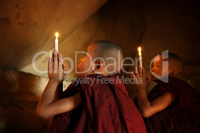 Buddhist novices praying