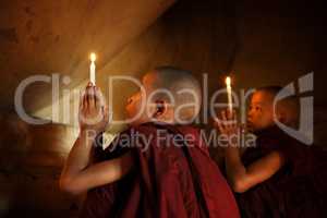 Buddhist novices praying