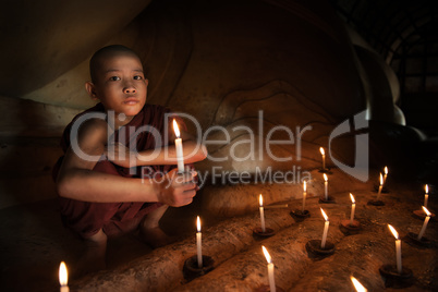 Buddhist novice with candlelight