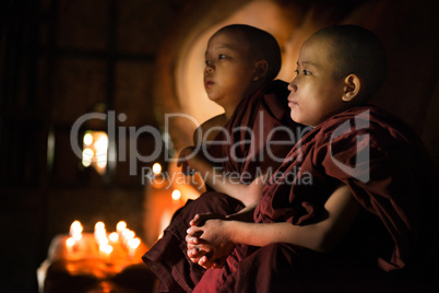 Buddhist novices praying inside temple