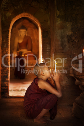 Buddhist novices praying in monastery
