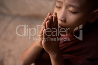 Close up Buddhist novice monks praying