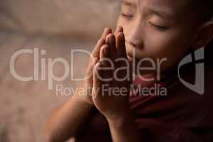 Close up Buddhist novice monks praying