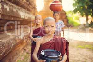 Buddhist novice monks collecting foods