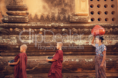 Buddhist novice monks collect alms