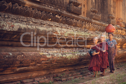 Buddhist novice monks walking alms