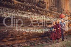 Buddhist novice monks walking alms