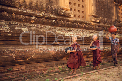 Buddhist novice monks walking alms in Bagan