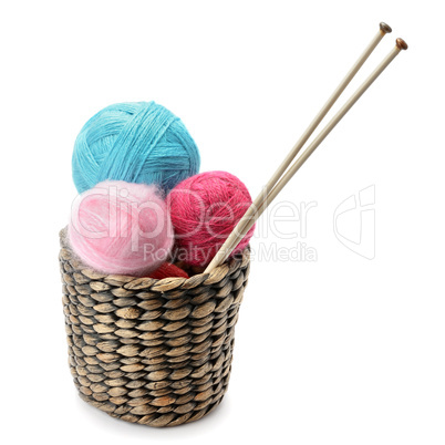 balls of wool and knitting needles isolated on a white backgroun
